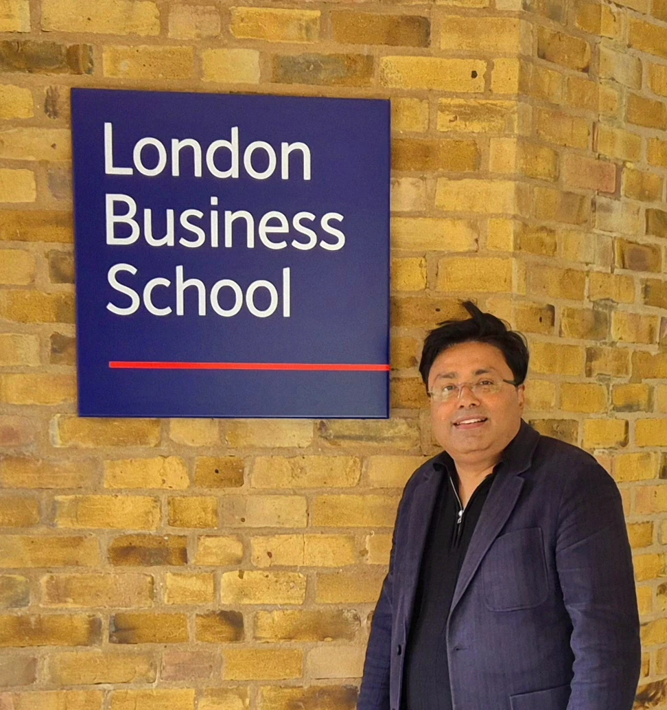 PK Das beside the London Business School sign